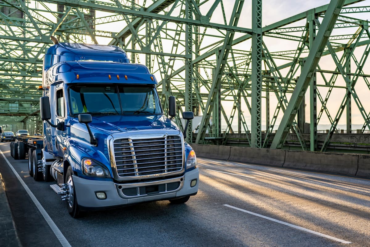 Blue Semi Truck on a green bridge